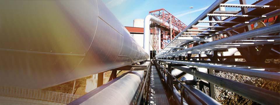 Industrial zone, Steel pipelines and valves against blue sky