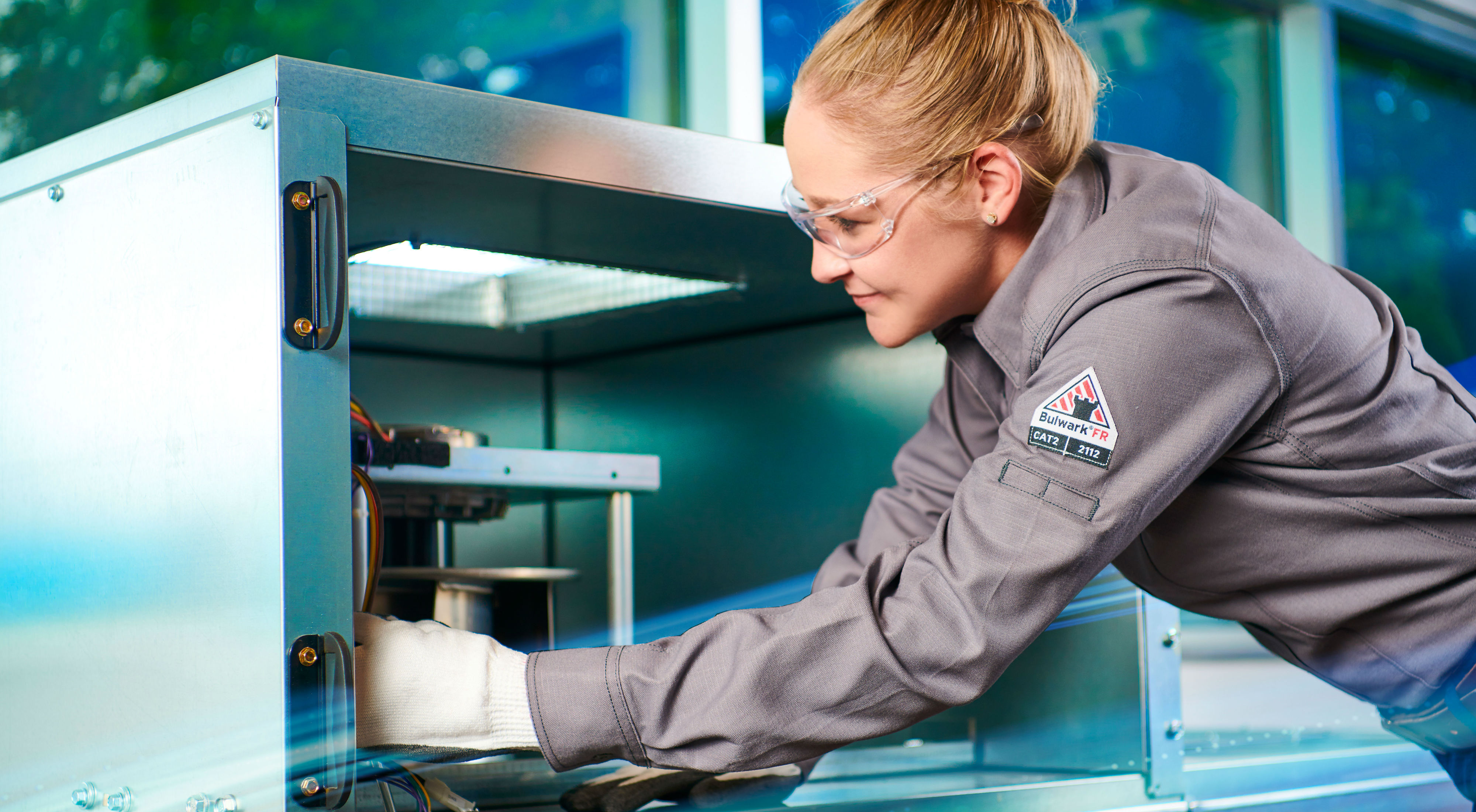 Female technician servicing an HVAC unit