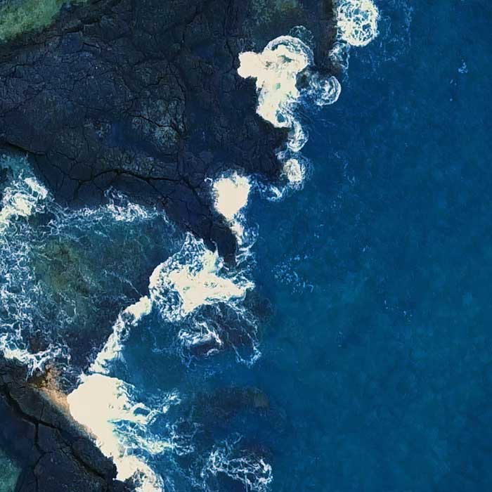 aerial view of deep blue ocean and coastline